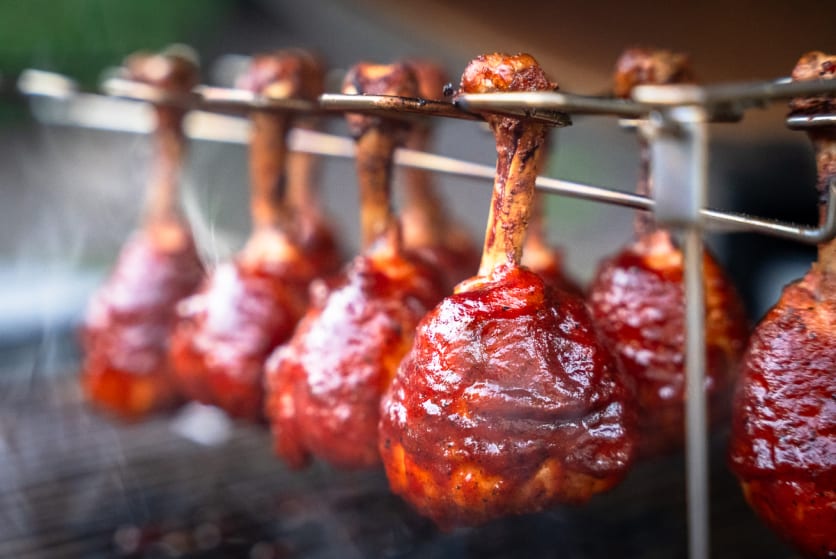 Chicken lollipops on the grill after applying the BBQ sauce