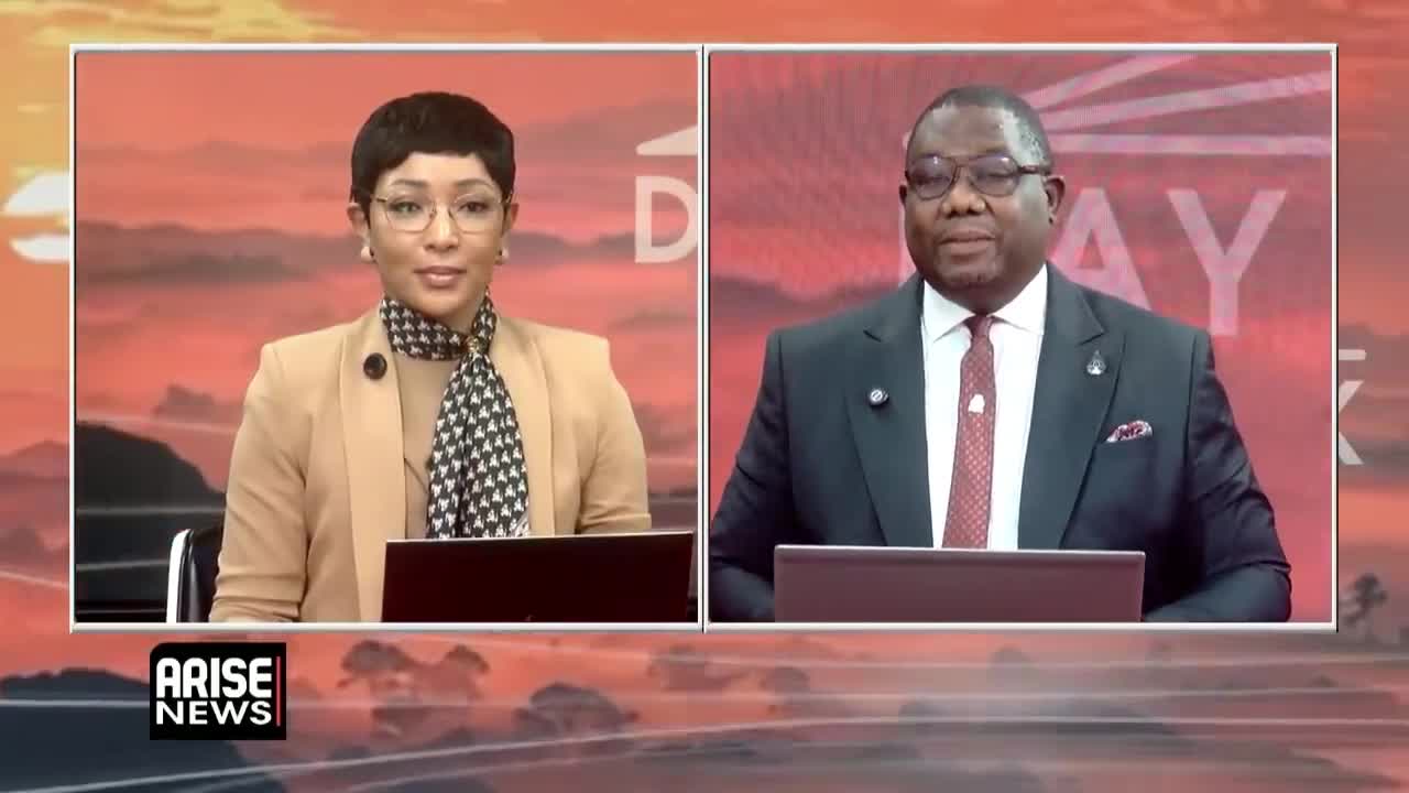 Yolanda Robert presenting in the Arise News studio alongside a co-presenter, facing camera at the newsroom desk