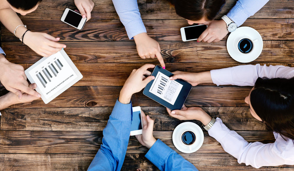 who-is-fbr-for-roles overhead view of a team of people working together with tablets and phones