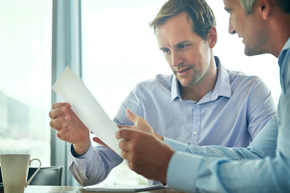 Candidate-Interview Businessman looking over a paper during an interview