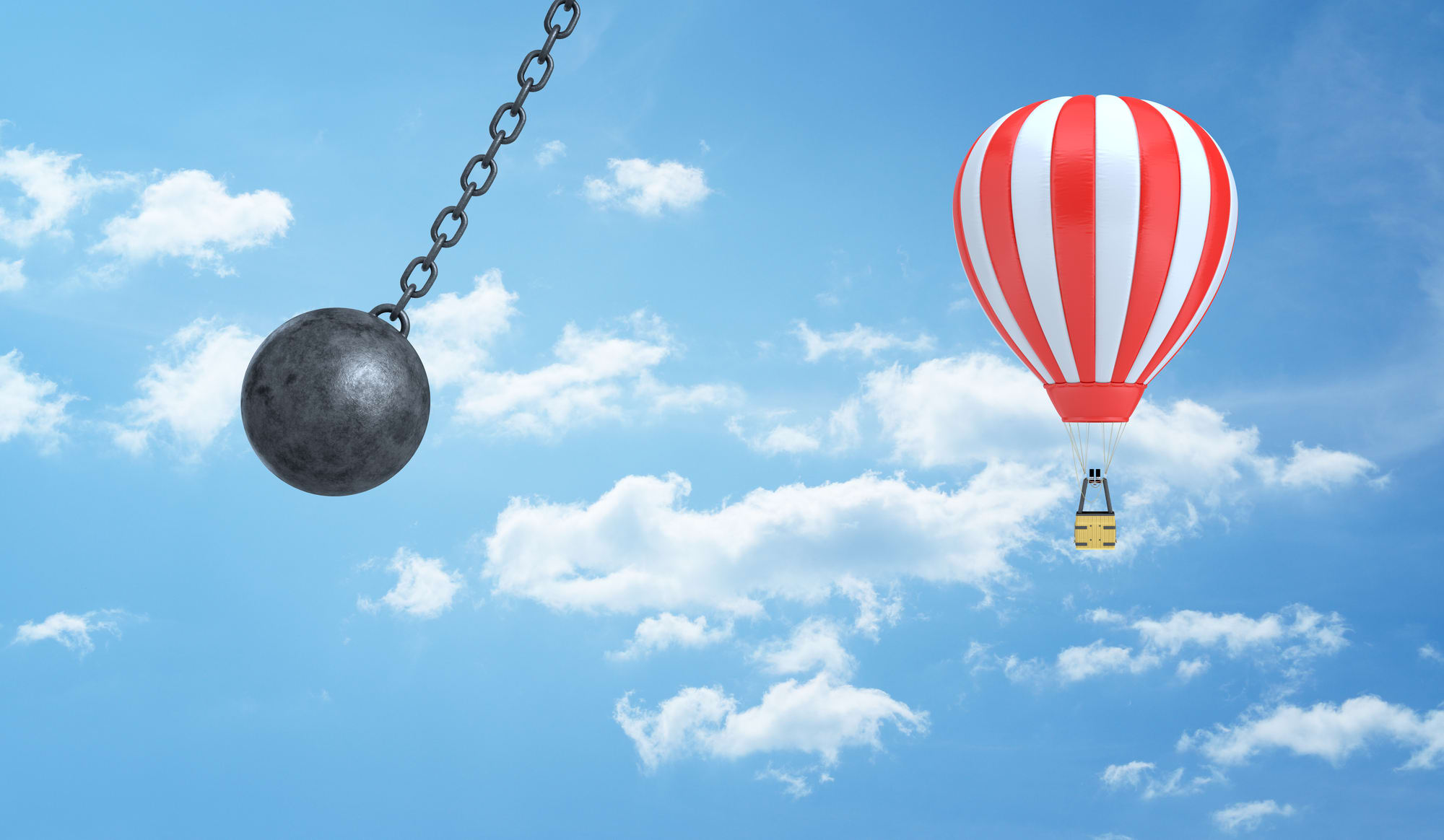 3d rendering of a giant wrecking ball dangerously swings near a striped hot air balloon on a clouded sky background. Wrecking ball swinging at air balloon