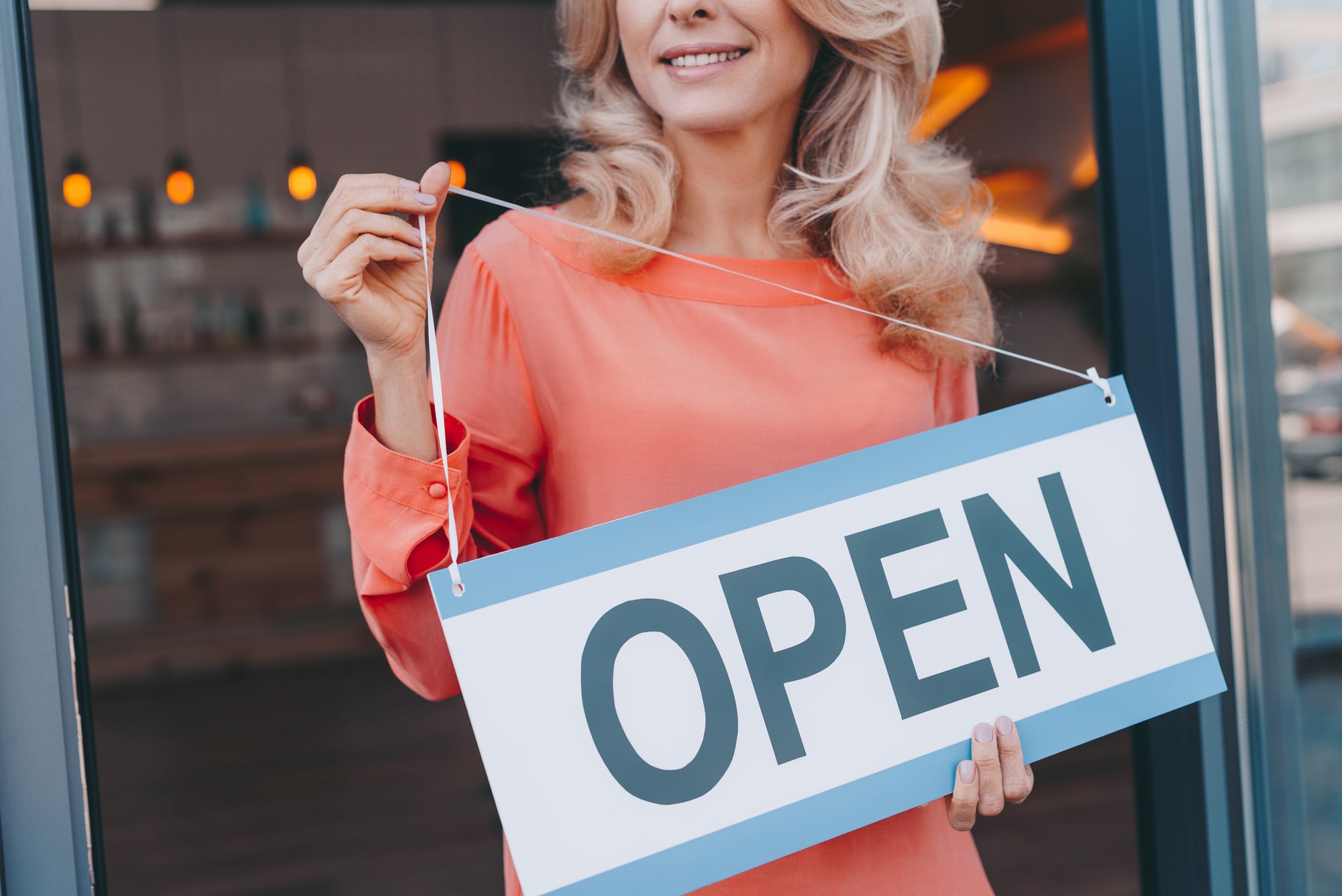 open sign at cafe Franchise owner with open sign