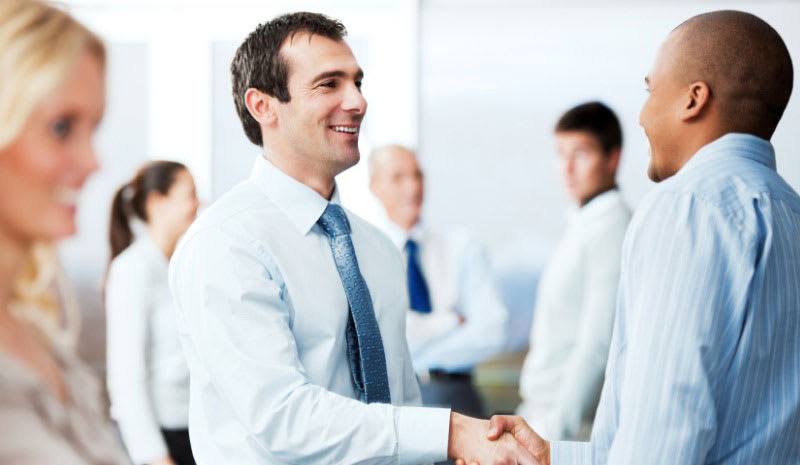 lead-generation-handshake Men in formal clothing smiling and shaking hands
