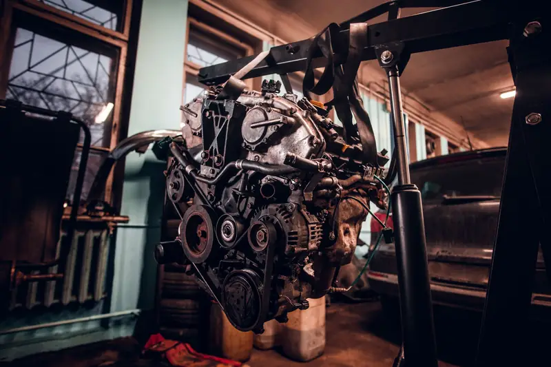 Engine removed from heavy equipment on a workshop hoist