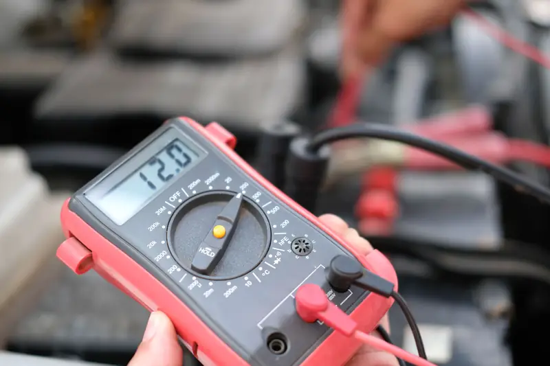 Multimeter reading battery voltage during electrical diagnostics