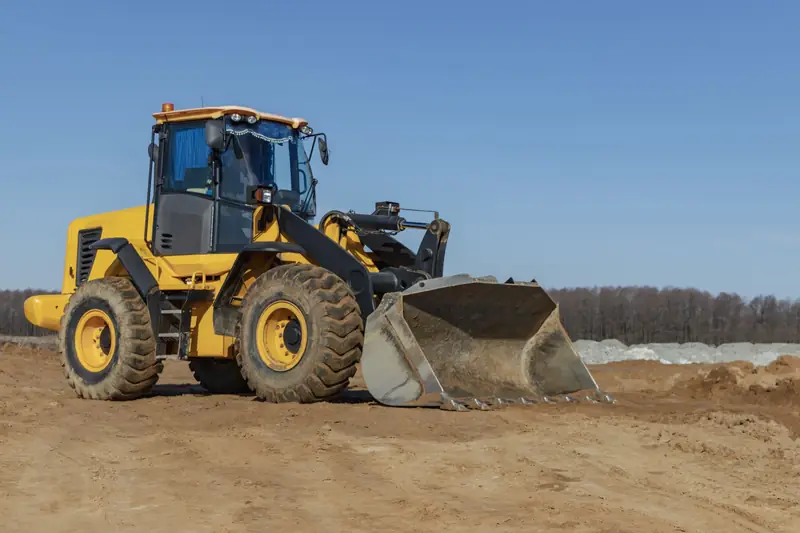 Wheel loader with a full bucket on a job site