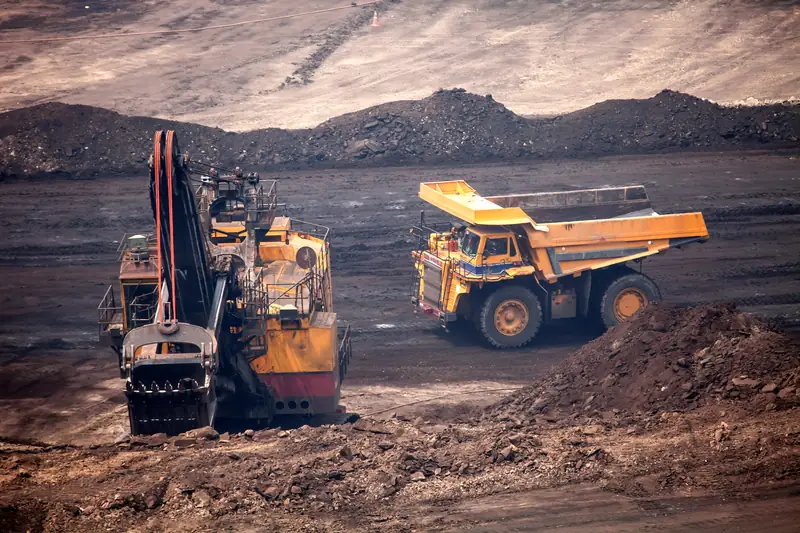 Mining excavator and haul truck at a surface mine