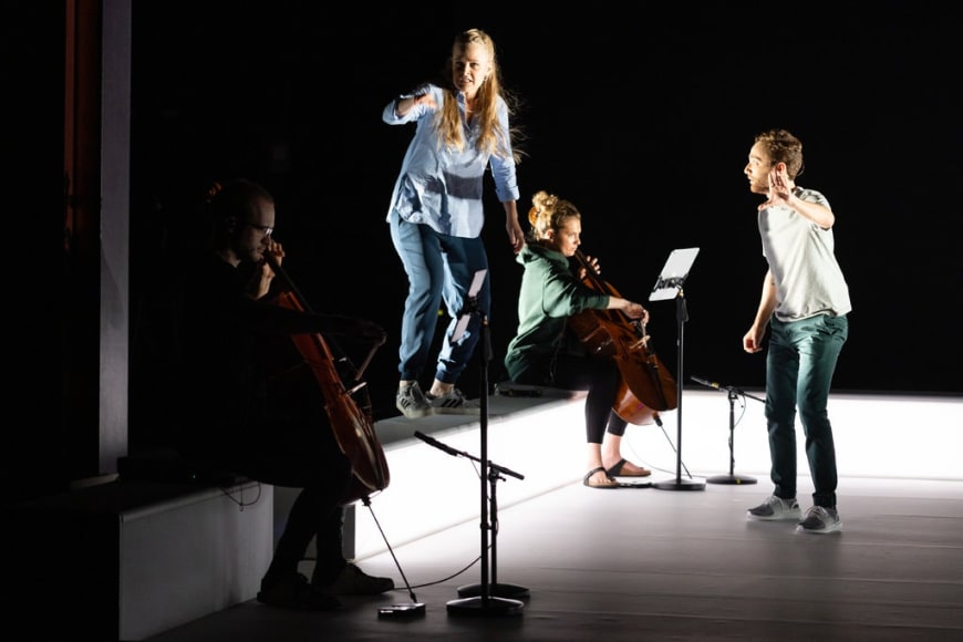 Siena Licht Miller (standing on bench) and Theo Hoffman (right) at Opera Philadelphia