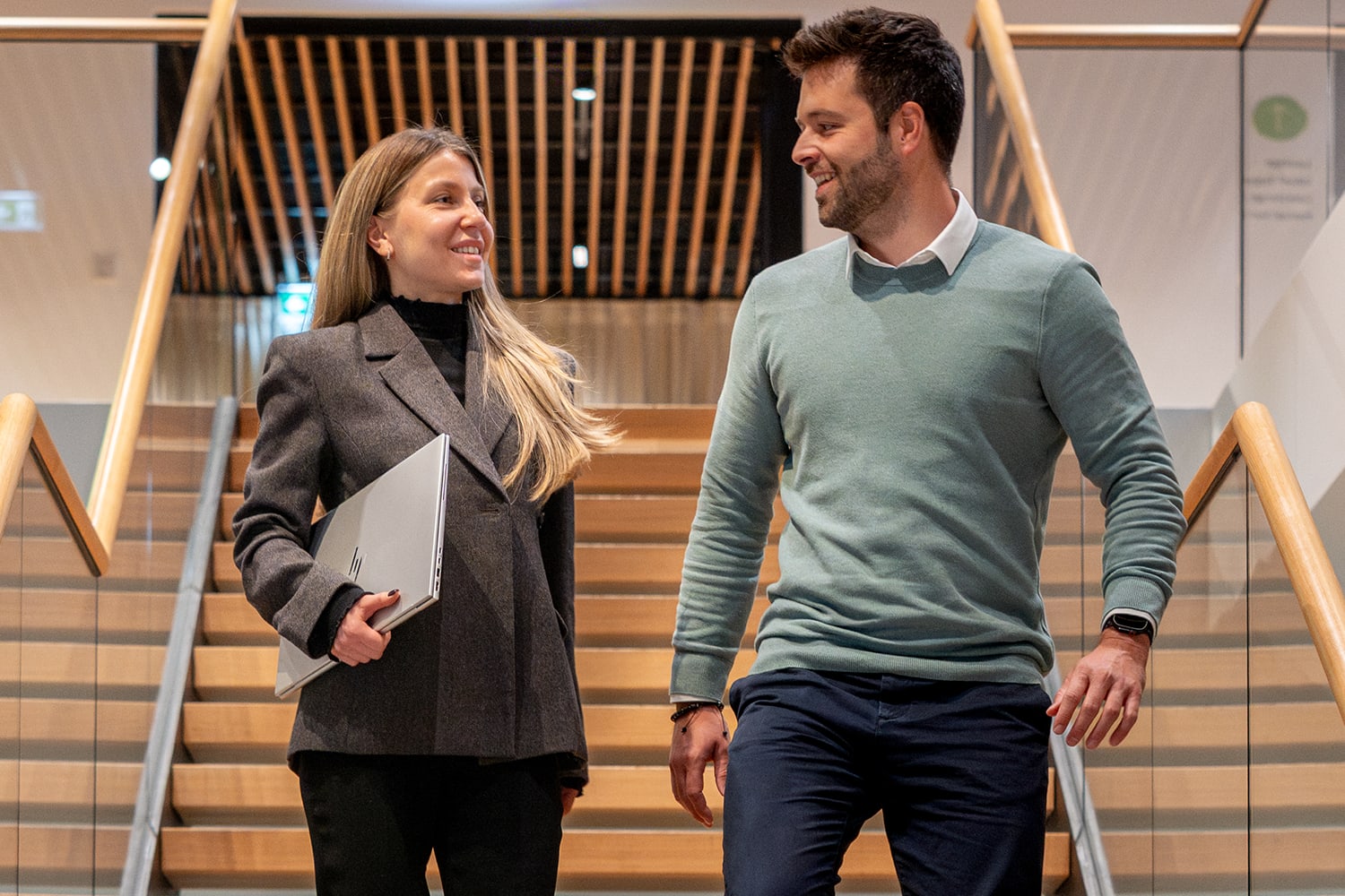 Zwei Kolleg:innen, die eine Treppe runtergehen