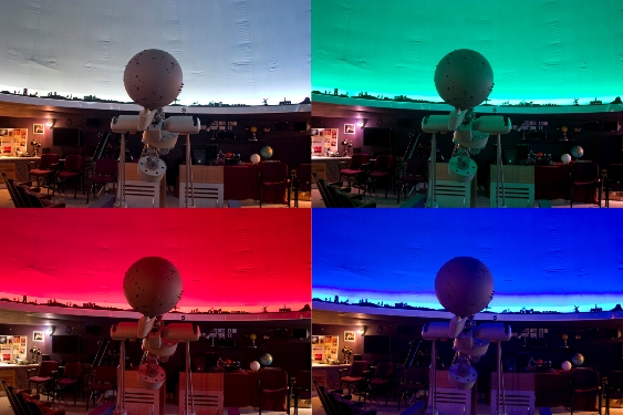 Inside Wynyard Planetarium with its projection dome lit in different colours