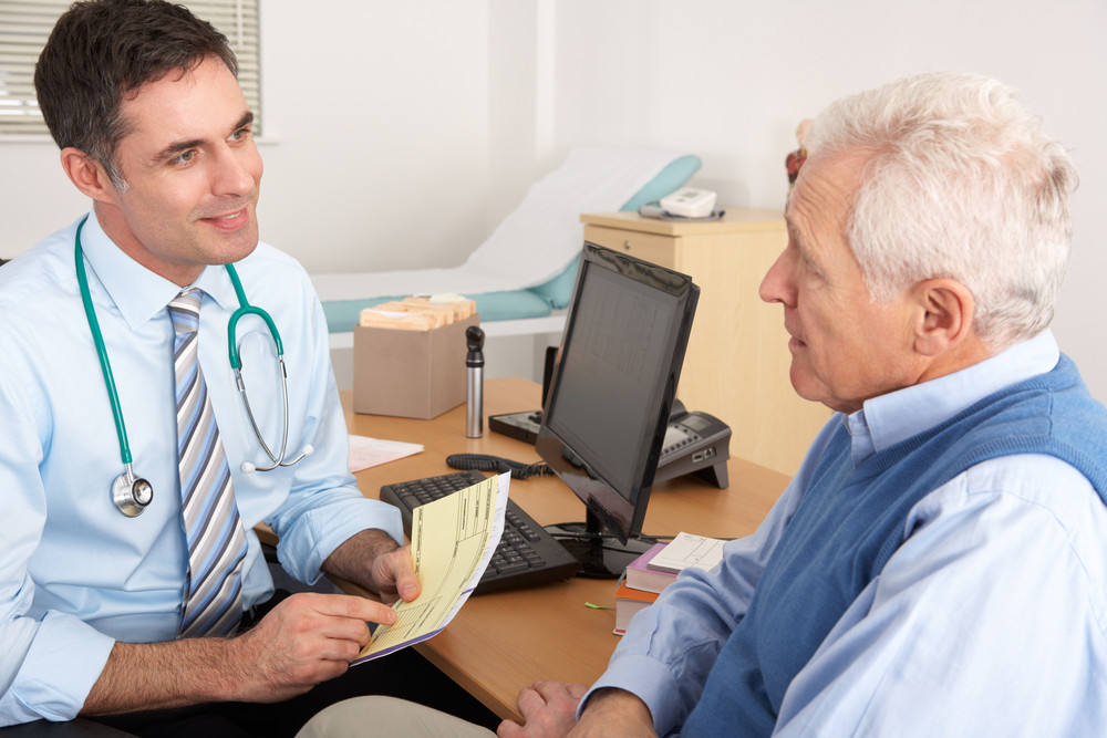 A GP speaking with an older patient, illustrating research into social prescribing