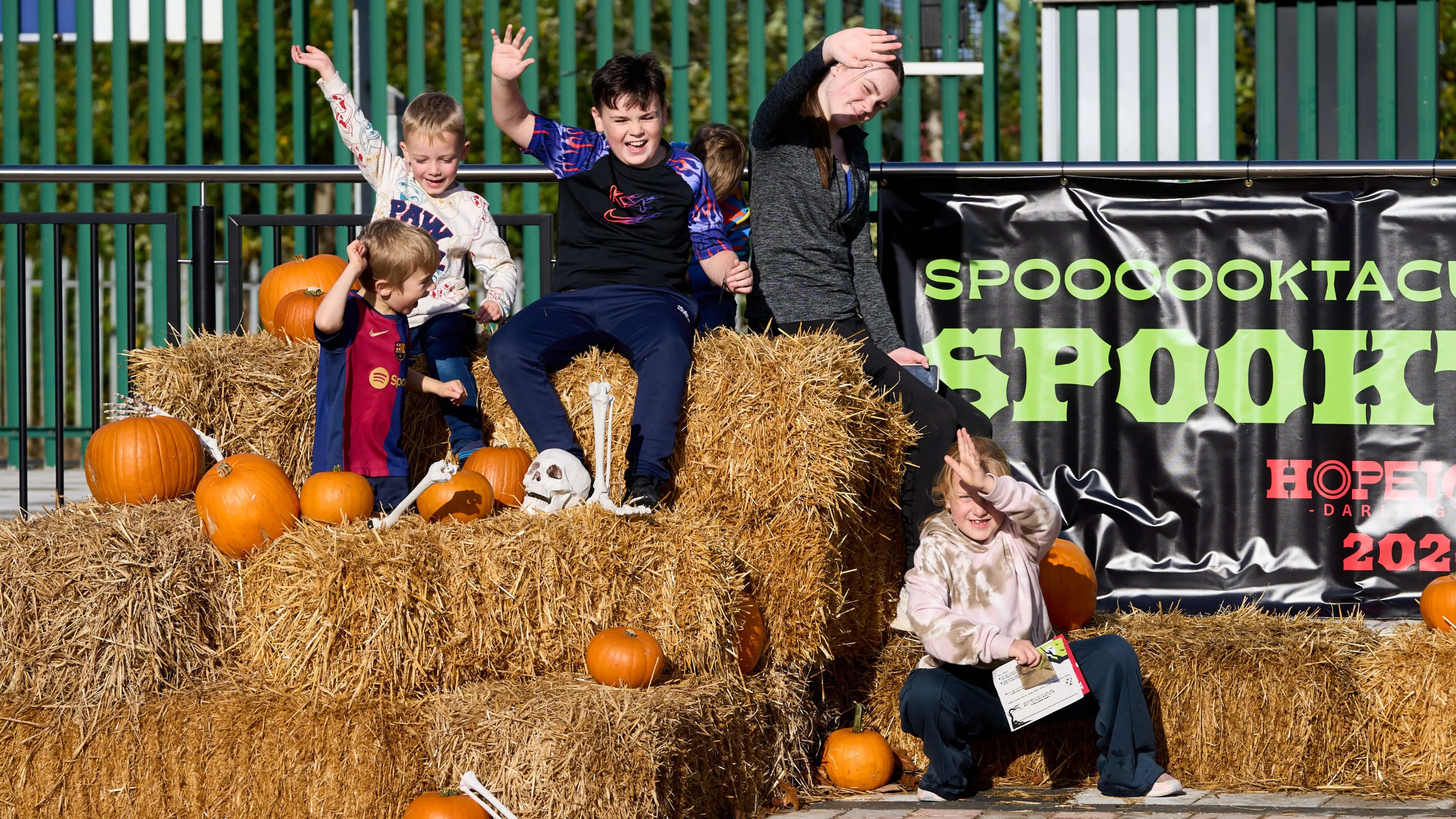 Children enjoying a previous Spooktown Halloween event at Hopetown Darlington among pumpkins and hay bales