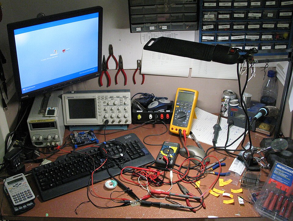 An electronics workbench with tools and testing equipment; illustrative apprenticeship image.