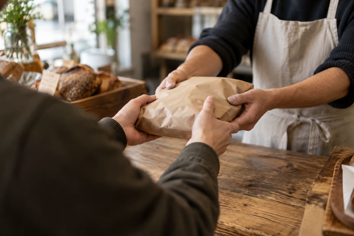 Hands across the counter as an order changes hands