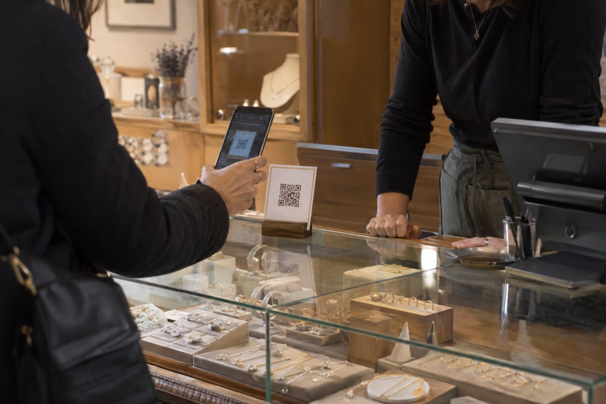 A jeweller's counter, a customer scanning at the display case