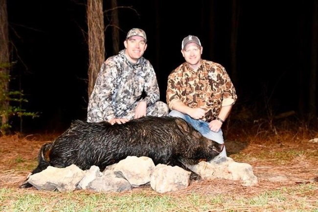 First time customer, Ryan and long time friend, Gabe, pose with Ryan’s first boar. Nice shot.