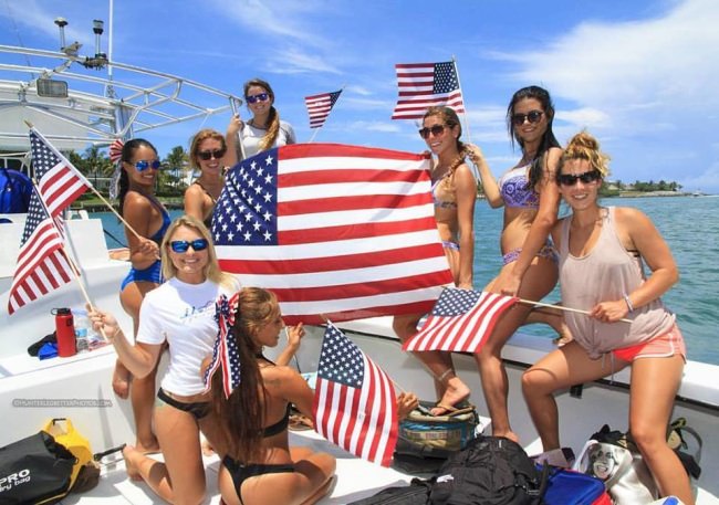 Lady shark divers salute Independence Day! Great photo from Hunter Ledbetter. #4thofJuly #Adventure #USA #FinandField