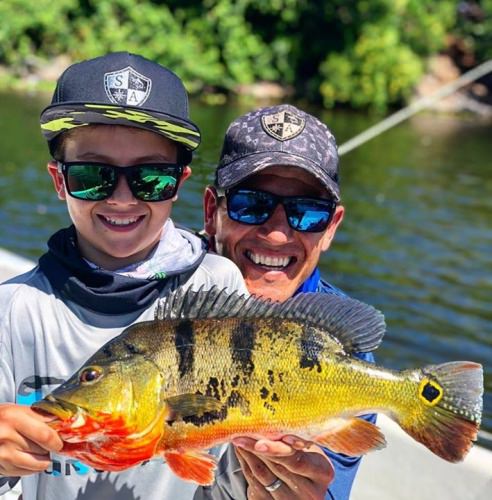 This young angler looks awful happy. Book your South Florida Bass Charters fishing adventure today. #Fishing #Bass #Florida #FinandField