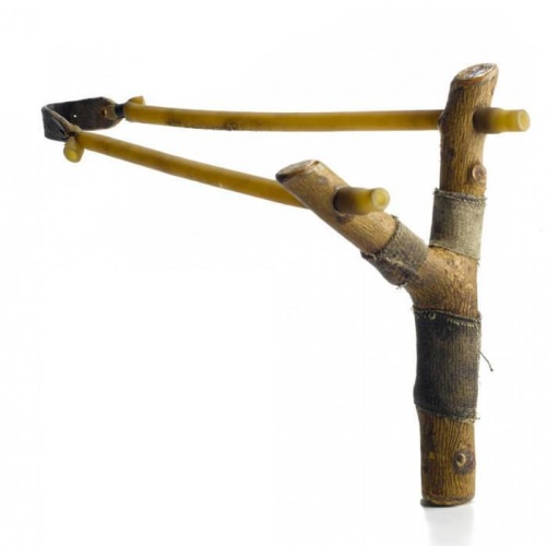 How to Make a Handmade Slingshot // By T. Edward Nickens

While we're not suggesting hunting with it, here's how you make a slingshot using tubing and, yes, a forked branch.

Madison Parker is a former U.S. Navy SEAL who now trains SEALs in wilderness skills—including how to make and wield the most wicked slingshots on the planet. How wicked? Parker's handmade slingshots fire big chunks of lead at 225 fps. Where legal, he's used them to take game from squirrels to wild turkeys and more. While we're certainly not suggesting you hunt with a slingshot, there's nothing wrong with drilling empty cans on a summer afternoon. Here's how to make one:

The Frame
“Dogwood, hickory, and oak are the best,” Parker says. “Don't look for the perfect Y-shaped fork. If you'll hold the slingshot in your left hand, you want a fork where the main branch crooks to the left at 30 degrees, and a fork that goes off to the right at a 45-degree angle. Cut the frame and let it dry for three weeks.”

The Power
Parker's slingshots utilize high-powered bands with heavy leather shot pouches, but a number of companies sell ready-made replacement bands with pouches attached for slingshots (slingshotworld.com). The trick is in Parker's connection: 1 1/2 inches from the top of each upright, drill a hole slightly smaller in diameter than the band. Bevel the end of the band with scissors and thread it through the hole. Snip off the bevel. Next, take a dried stick slightly larger in diameter than the inside diameter of the band, and carve two pointed, 1/2-inch-long stoppers. Plug each end of the tubing with a stopper.

Photograph by Travis Rathbone