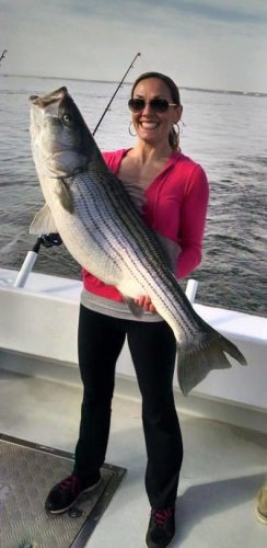 Amie hooks up before Dad, Brother, & Brother-in-law while fishing with Captain Pete's Fishing Charters on the Chesapeake Bay. #Fishing #CaptPete #Maryland #Rockfish #FinandField