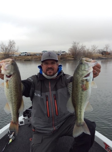 Catching bass in the cold and snow... SIMMS Pro Dry rain gear helping me stay warm and dry....