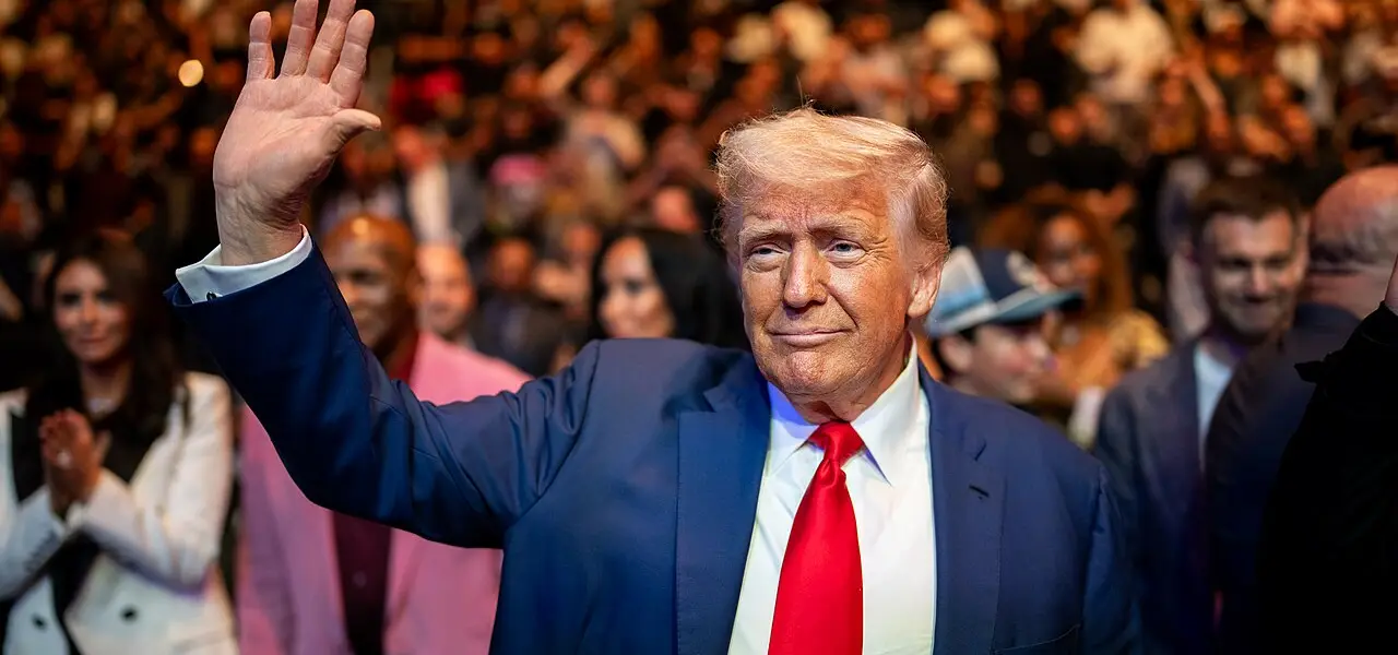 A man in a suit waving at a crowd, tied to U.S. policy discussions on Bitcoin reserves in 2025.