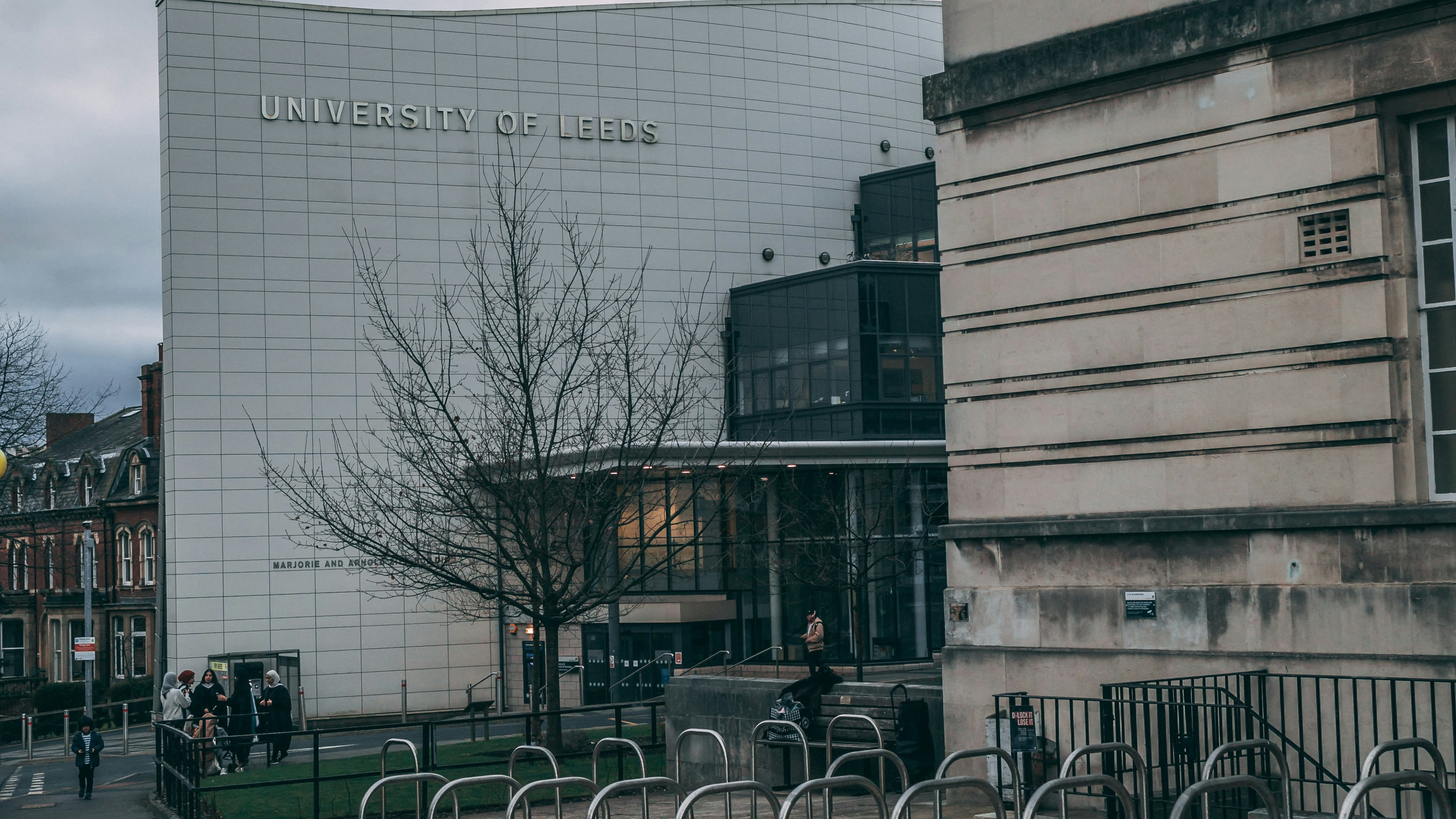 Students walk outside the University of Leeds' modern building, a popular destination for students moving to the city for their studies.