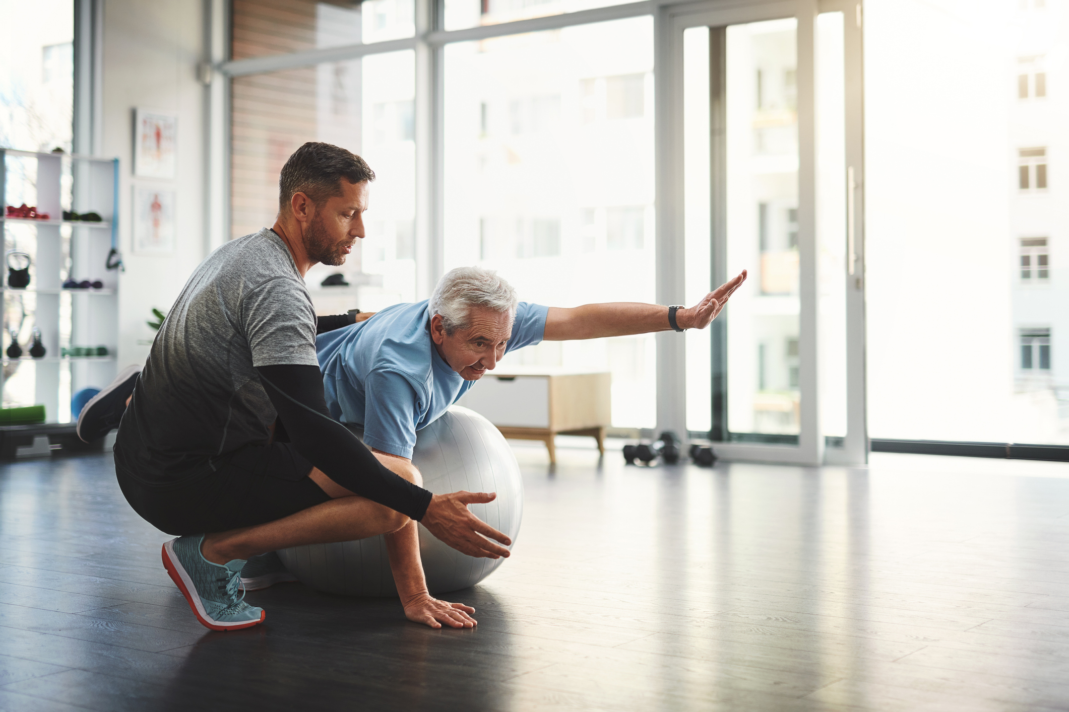 An old man getting physical therapy treatment from a physiotherapist