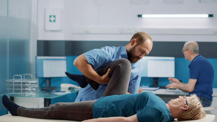 A physical therapist taking care of an elderly woman