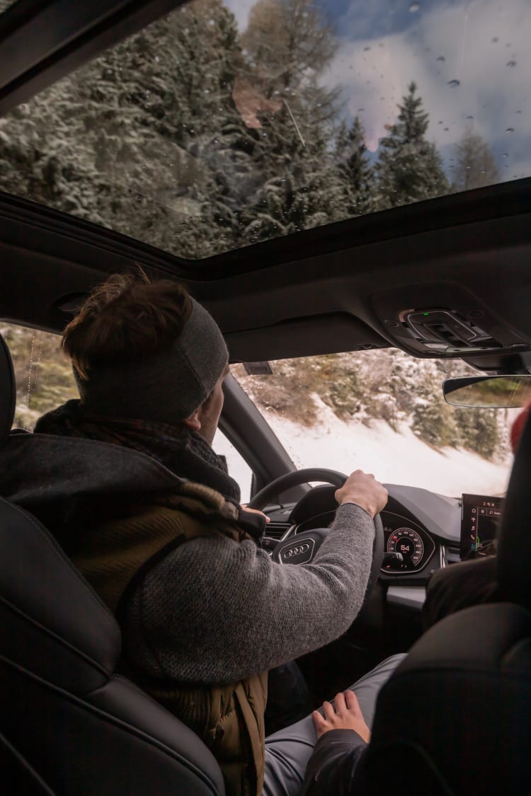 Ein Mann fährt im Winter Auto.