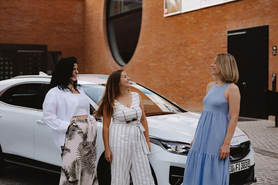 Friends next to a leased car in Germany