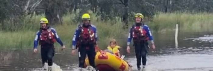 An image relating to the news item Firefighters rescue women and children from stranded car in floodwaters - Video