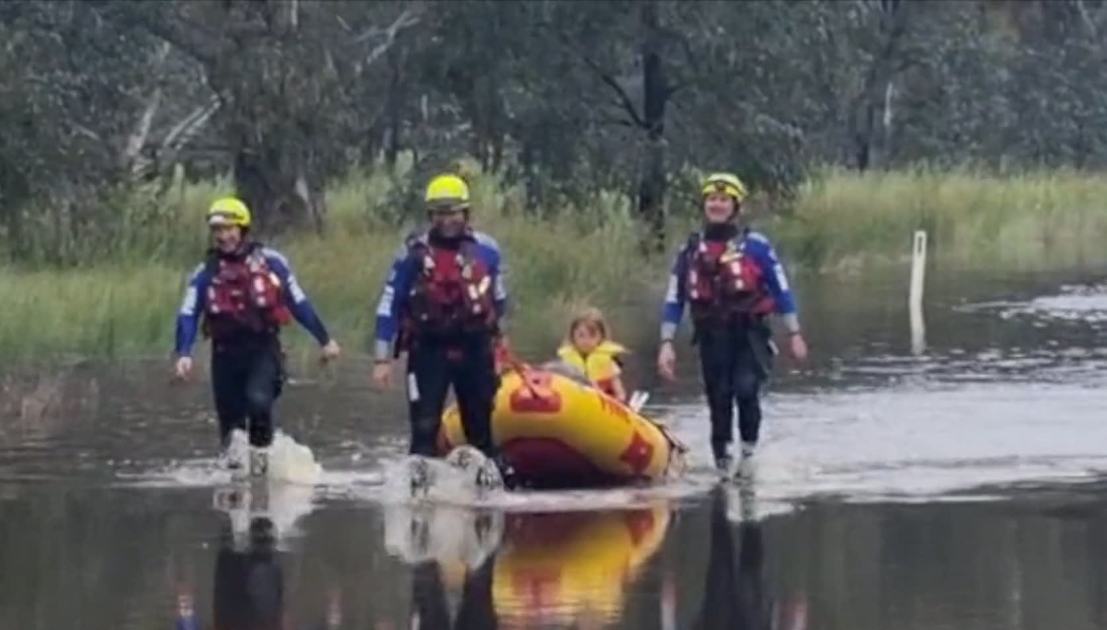 An image relating to the news item Firefighters rescue women and children from stranded car in floodwaters - Video
