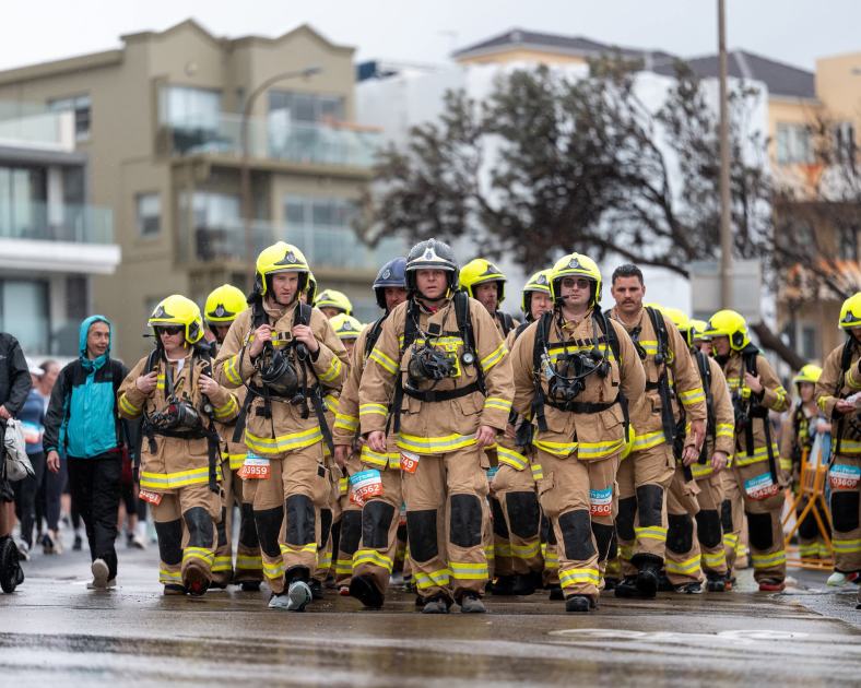 An image relating to the news item Firefighters cross City2Surf finish line in firefighting gear, raising over $150,000 for sick kids 