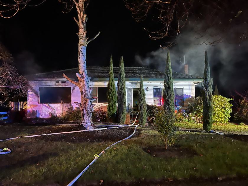 An image relating to the news item Firefighters enter burning home, rescue unconscious man
