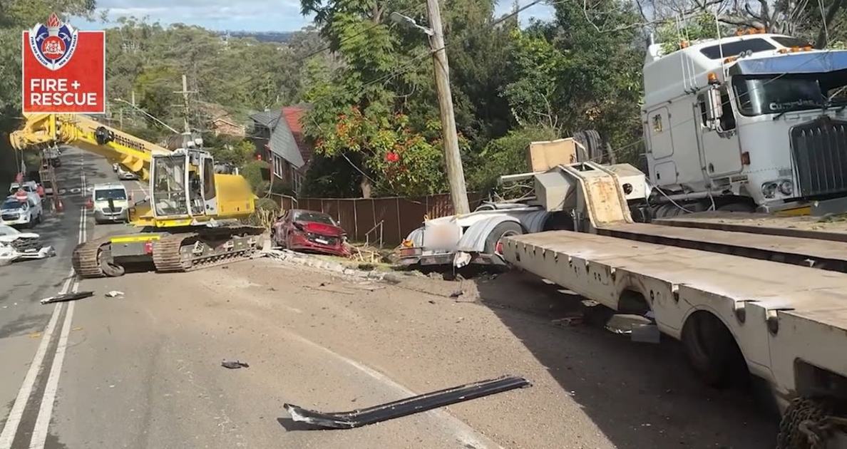 An image relating to the news item VISION ALERT *** Firefighters stabilise scene after runaway truck and crane career into 11 parked cars