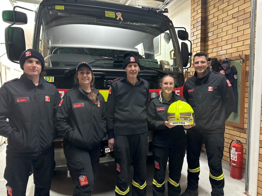 An image relating to the news item Firefighters ‘shooting the breeze’ about fire safety during local community basketball challenge