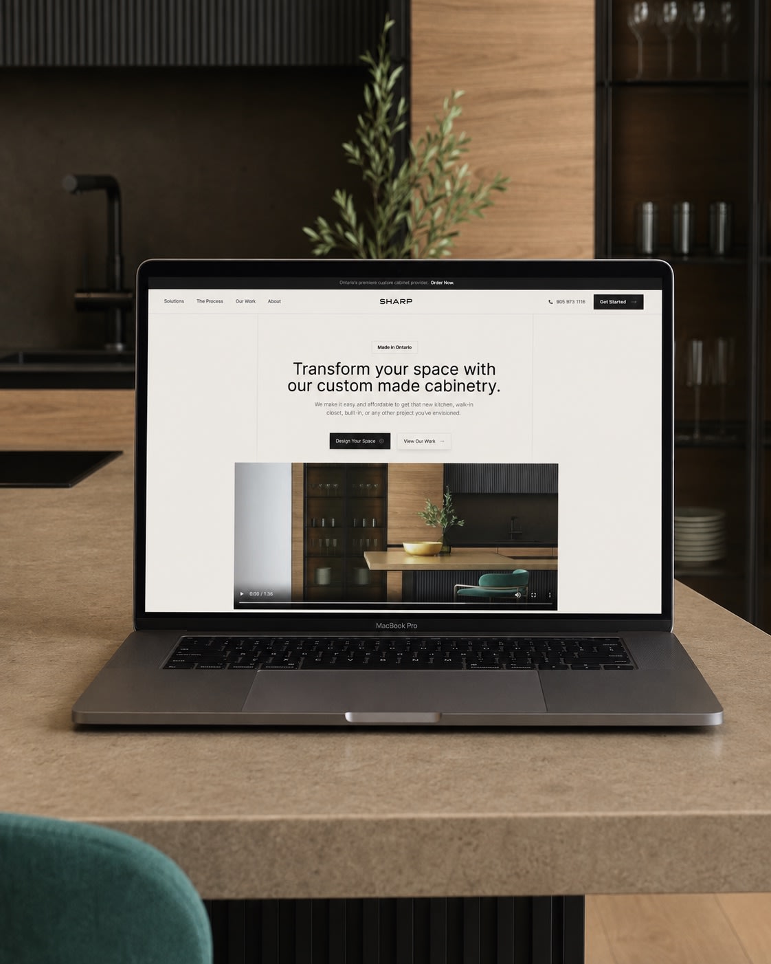 Sharp Cabinetry’s website on a laptop in a beautifully crafted kitchen