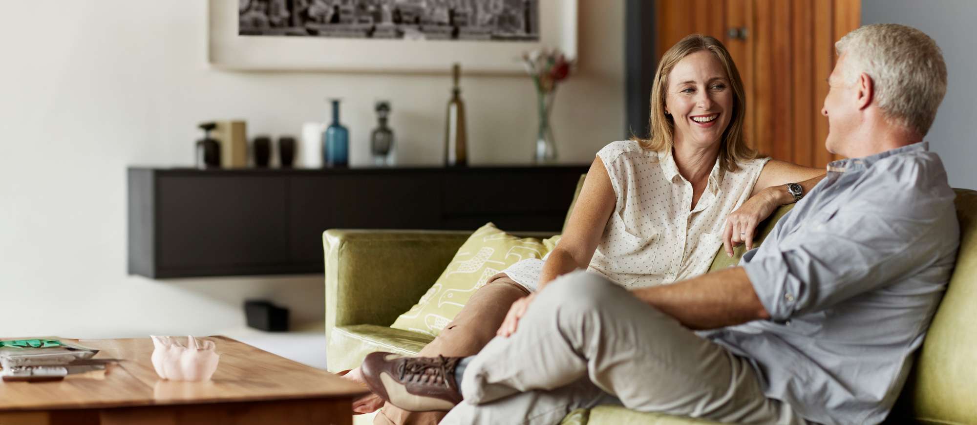 Couple sat down discussing smiling