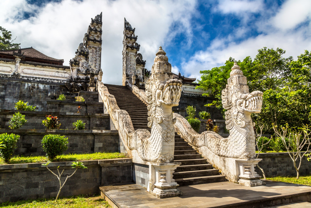 Ancient gate at Pura Penataran Agung Lempuyang temple and volcano Agung on Bali, Indonesia in a sunny day