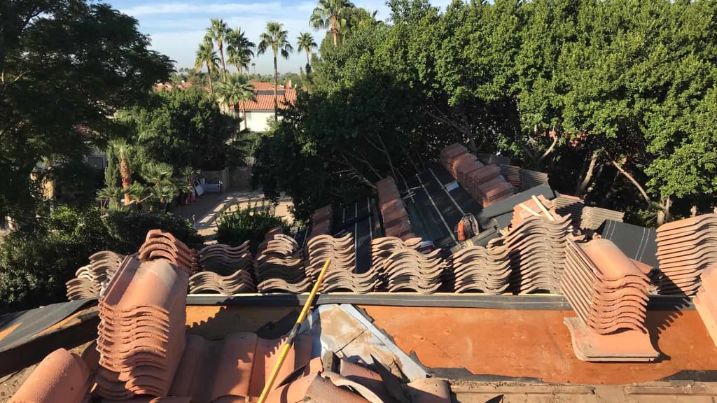 The KY-KO Roof stacks tile on top of this Scottsdale home's roof prior to starting the roofing project.