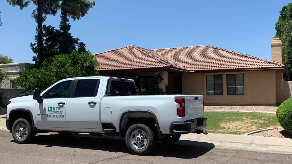 A KY-KO vehicle sits packed in front of this Valley home as our roofer prepares for a free roofing checkup.