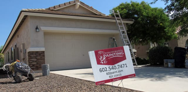 This Crash of Rhinos yard sign sits out front of this Chandler home, currently in the process of being painted.