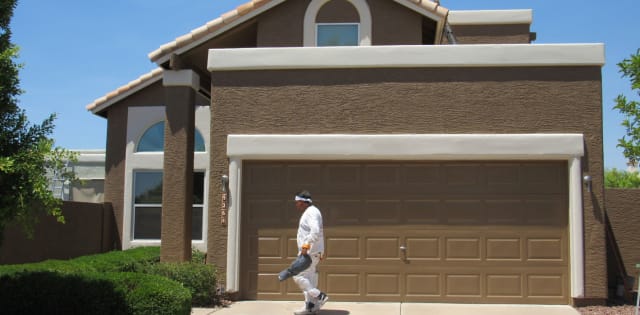 Our painter walks in front of a nearly completed home, as they prepare to put the finishing touches on this project.