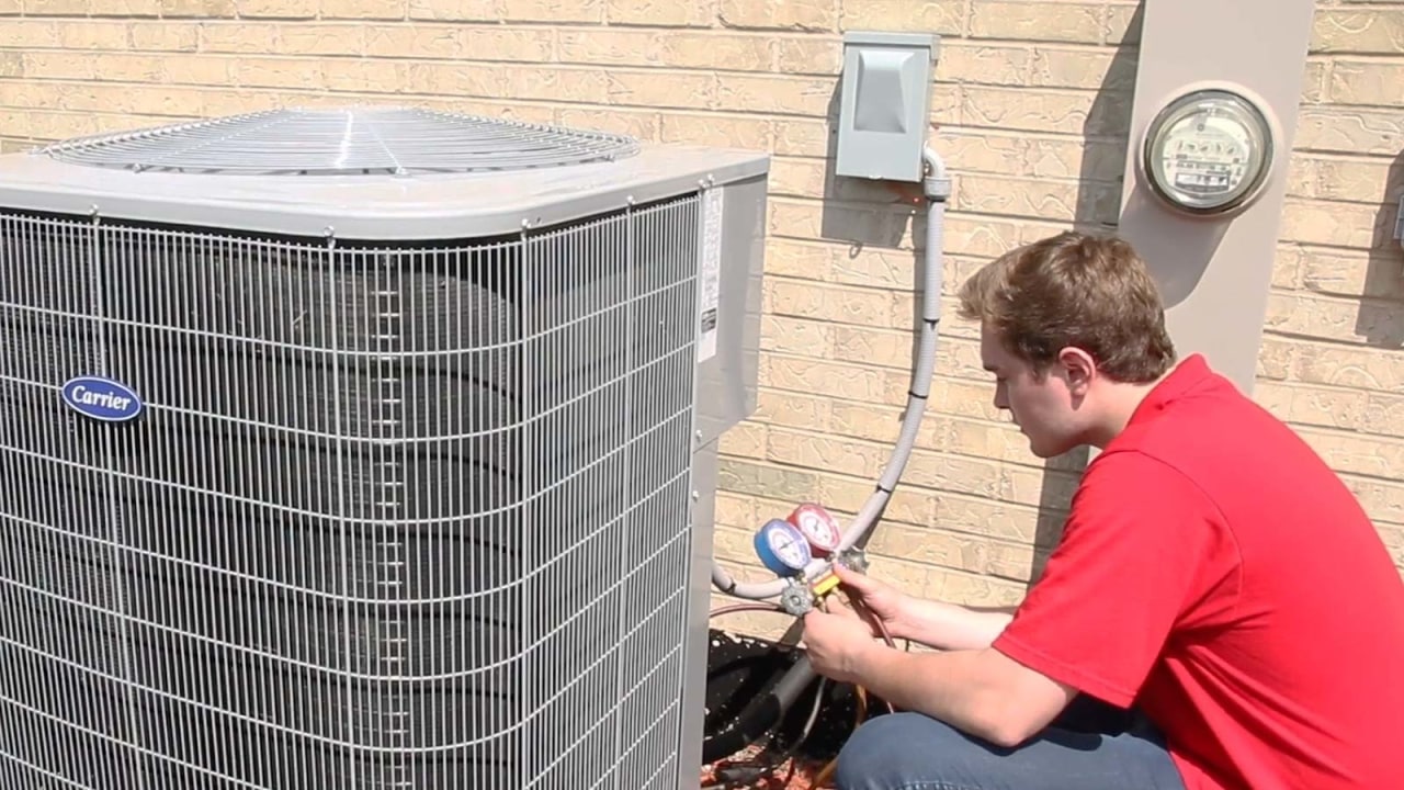 Using specialized equipment, a King technician performs seasonal maintenance on a local AC unit here in Chicago, IL