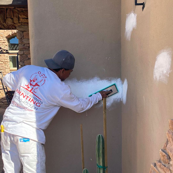 We specialize in stucco repair here in Phoenix, and our painters start by fixing woodpecker holes and other damage.
