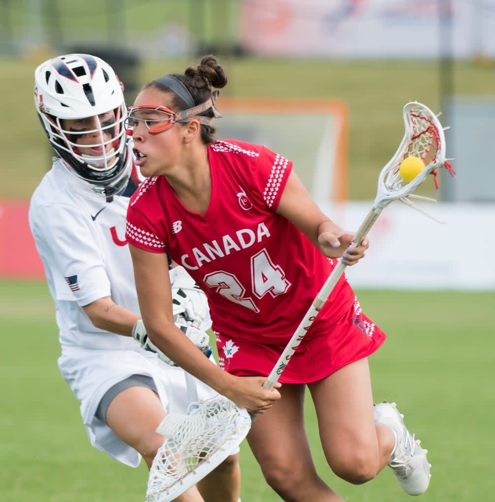 Canada's Alie Jimerson tries to avoid USA goal keeper, Devon Wills, at the 2017 FIL Rathbones Women's Lacrosse World Cup at Surrey Sports Park, Guilford, Surrey, UK, 15th July 2017