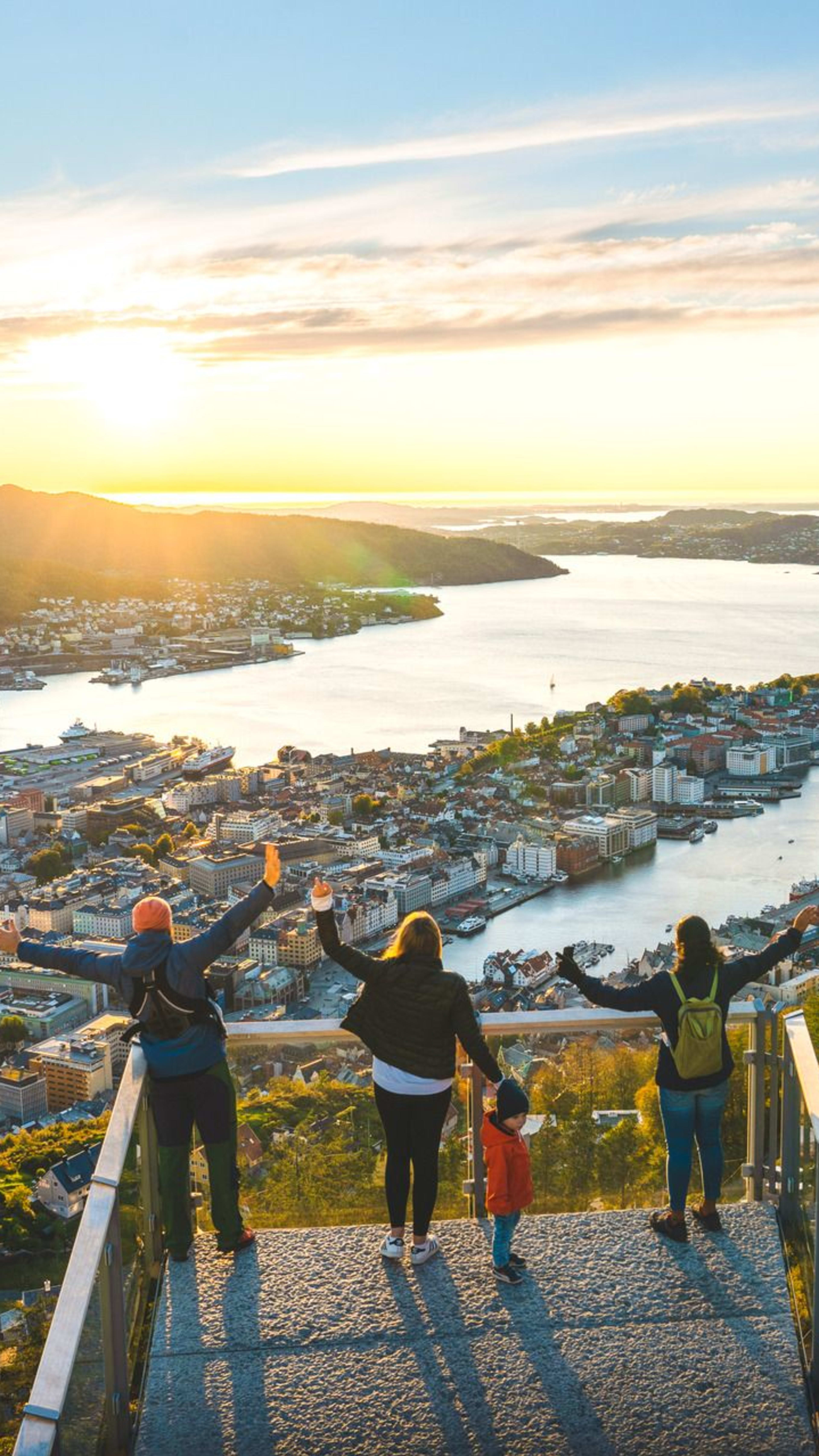 Besøkende på Fløyen utsiktspunkt nyter panoramautsikt over Bergen by, fjorder og omkringliggende fjell
