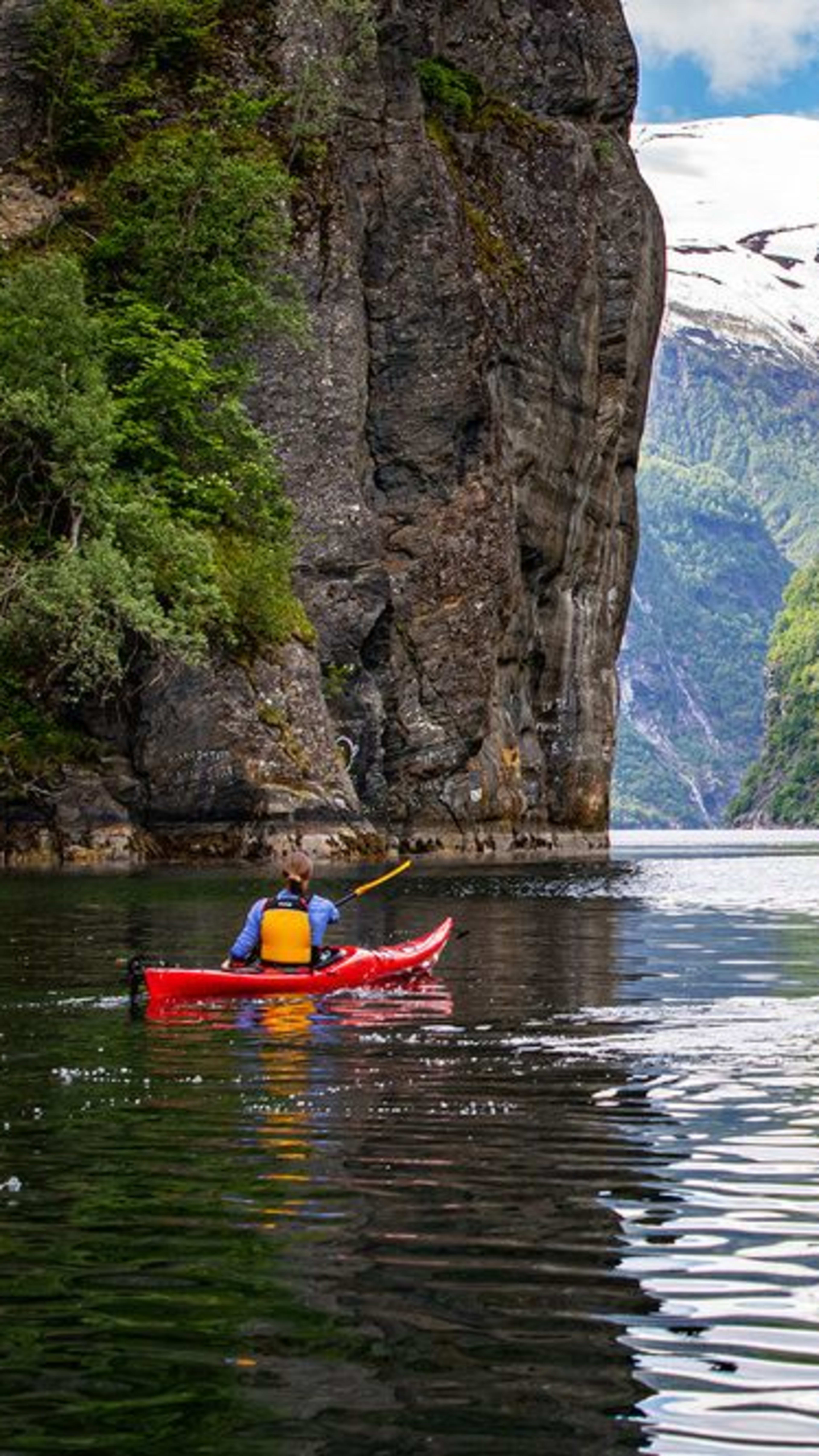 Kayaking on Geirangerfjord towards Seven Sisters waterfall - UNESCO World Heritage fjord Norway