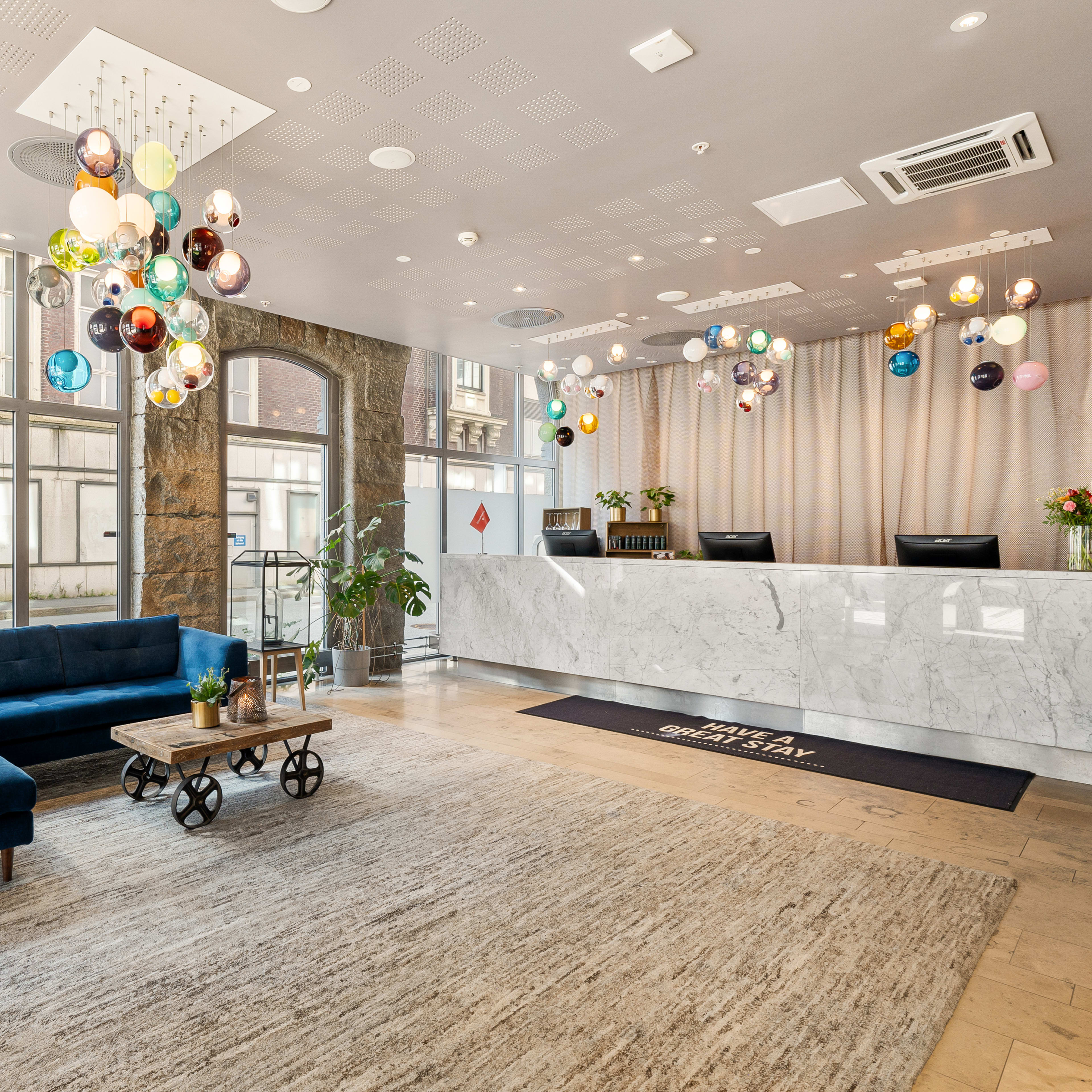 Elegant waterfront hotel lobby at Clarion Hotel Admiral in Bergen with harbor views and friendly reception area